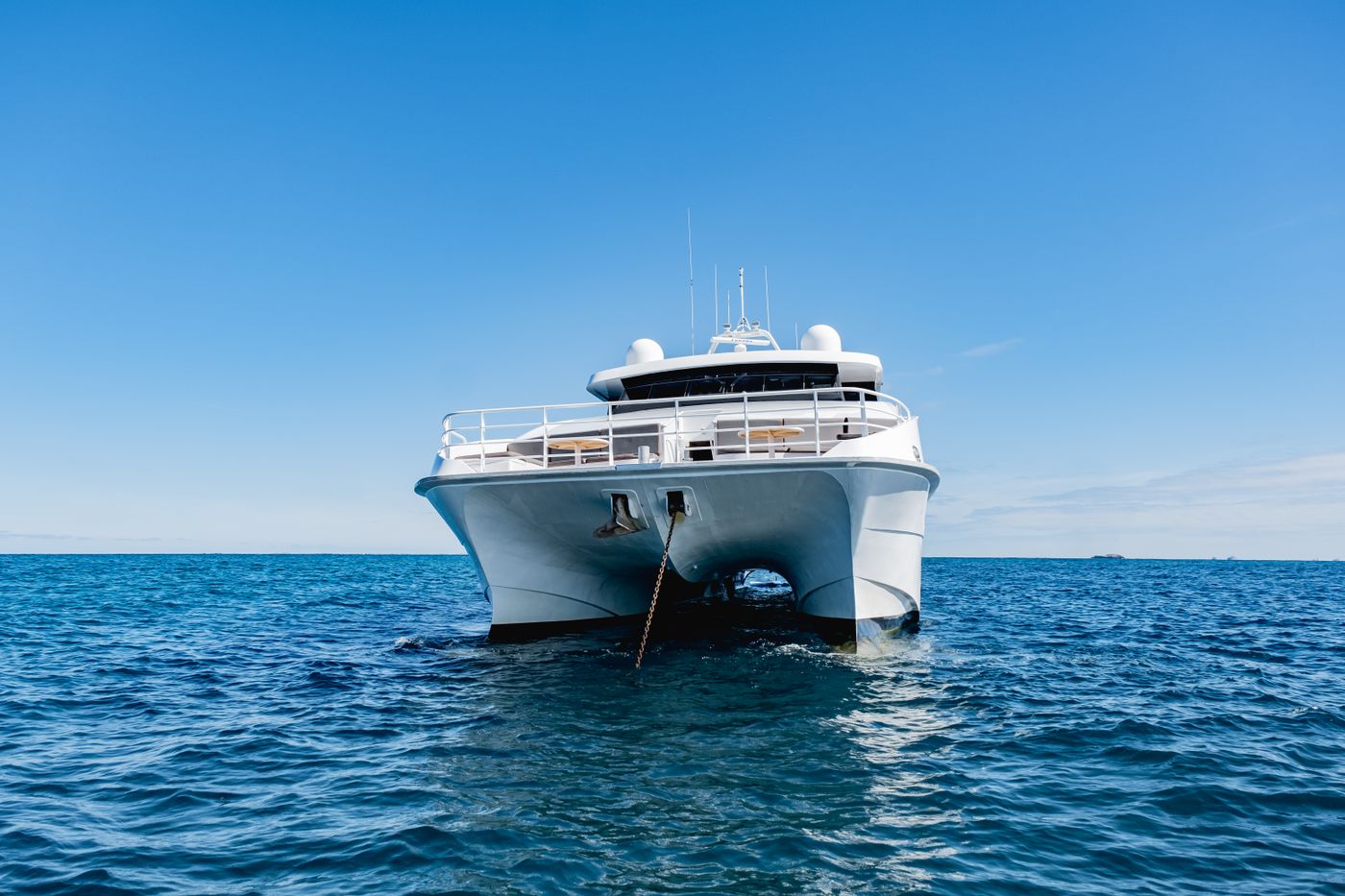 A white yacht against an open sea horizon